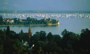 Szwajcaria, Jezioro Bodeńskie. Wiele żaglówek na wodzie, zamek i wieża widoczne na brzegu.